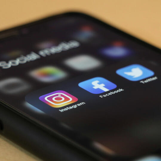 An image of a phone with social media icons.