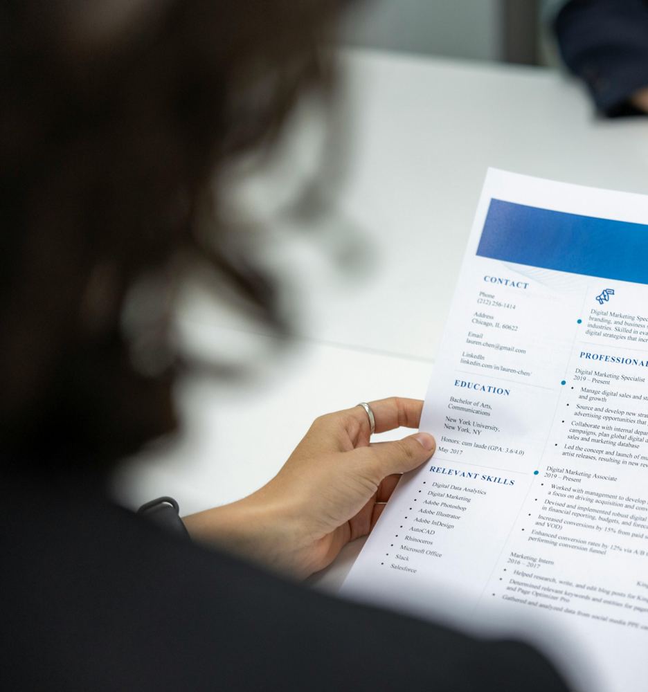 A person holding a printed resume